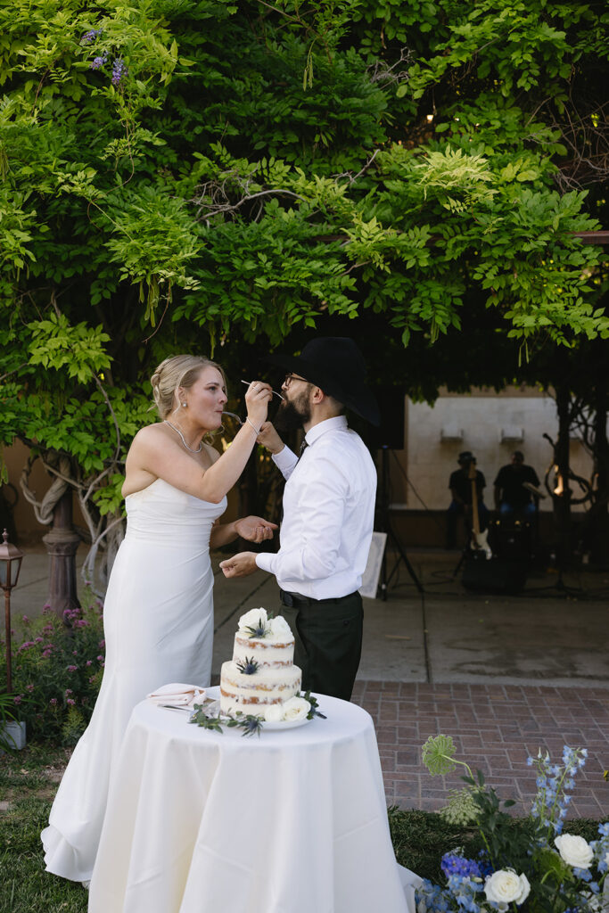bride and groom eating their wedding cake