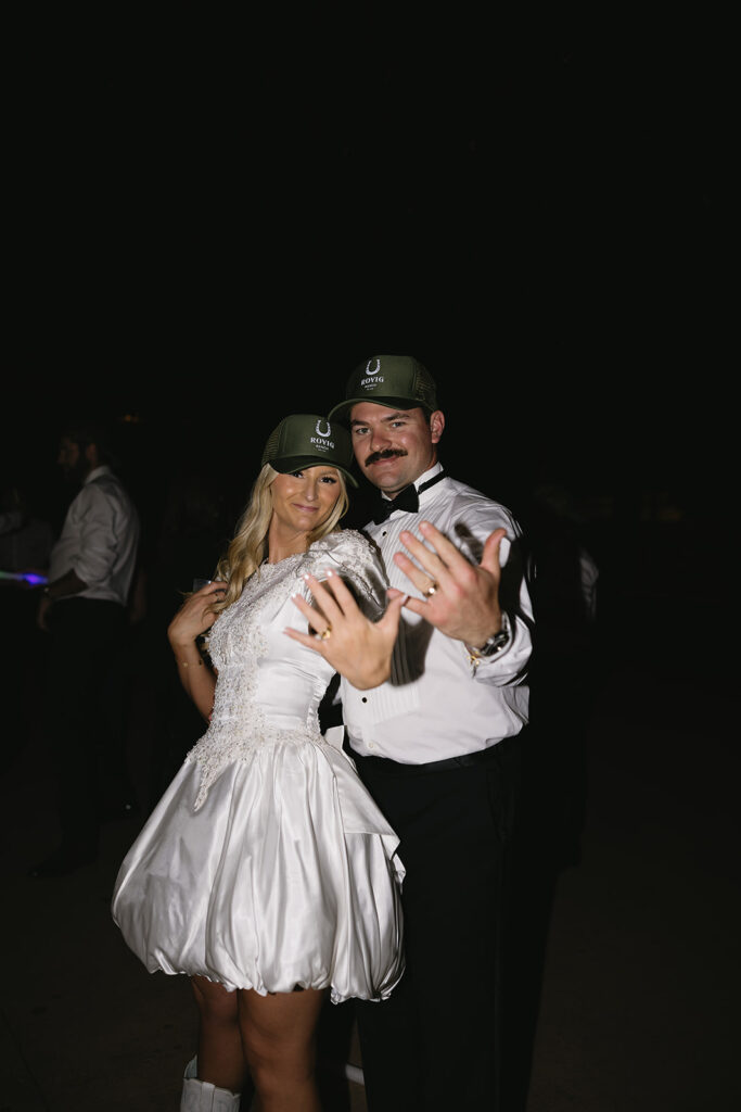 bride and groom wedding reception photos showing off wedding rings