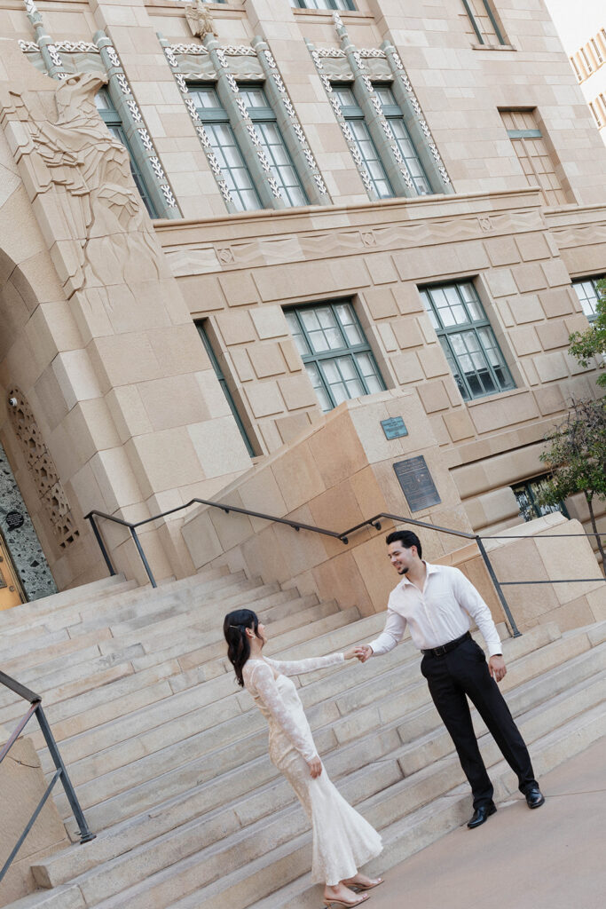 couple walking down the stairs in front of phoenix city hall