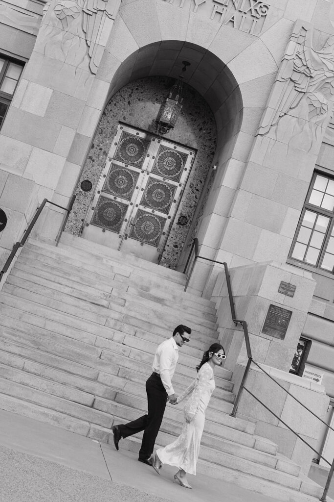 couple walking down the stairs in front of phoenix city hall