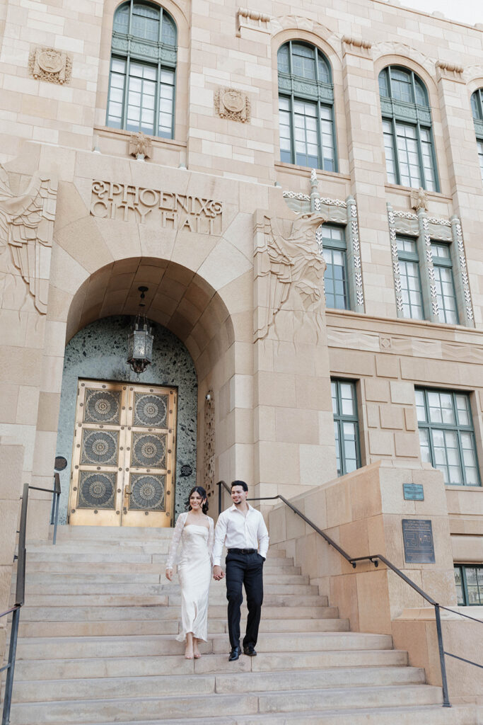couple walking down the stairs in front of phoenix city hall