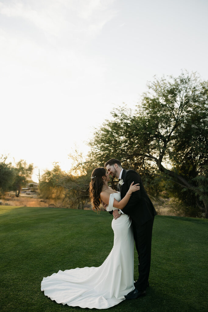 bride and groom portraits kiss pose with glowy golden light