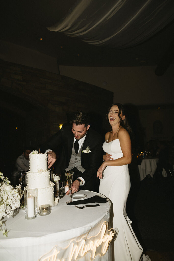 timeless bride and groom cutting the wedding cake photos during reception