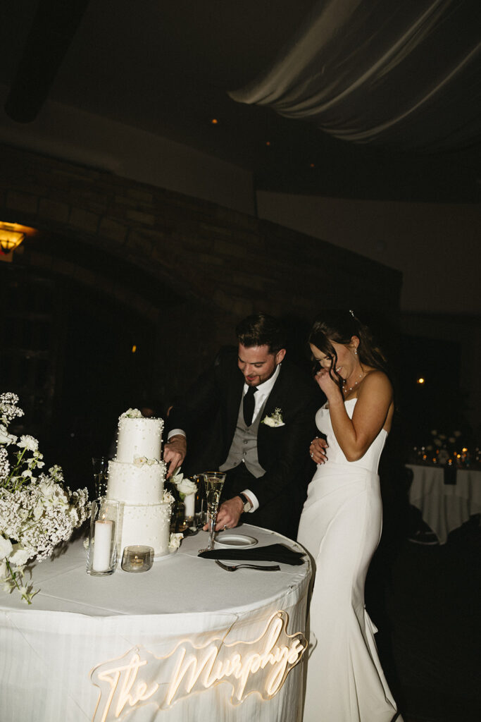 timeless bride and groom cutting the wedding cake photos during reception