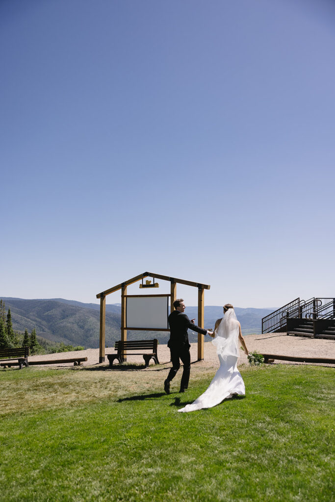 bride and groom holding hands walking outdoors