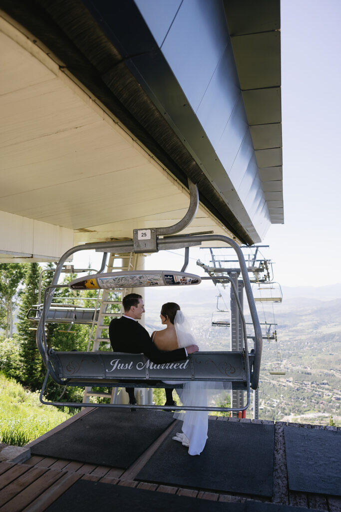bride and groom smiling at each other on a gondola