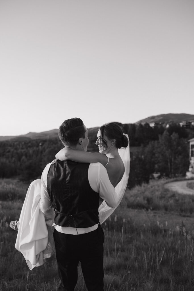 groom holding the bride during golden hour for wedding photos