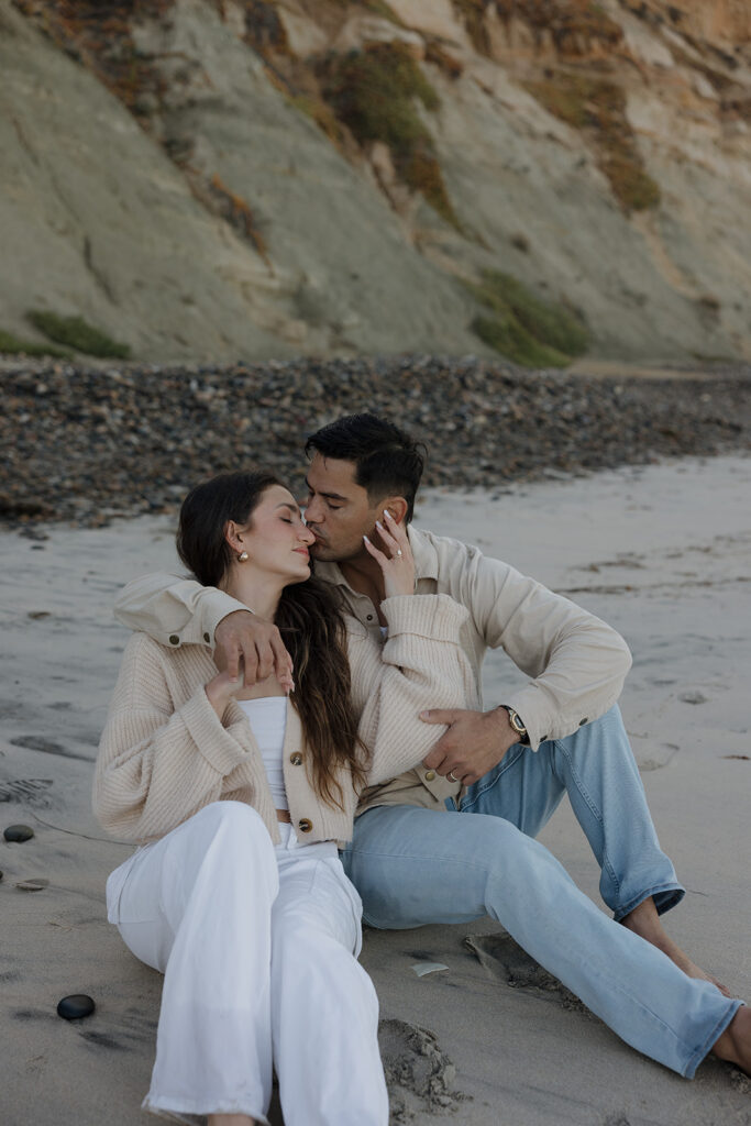 couple sitting on the shore at the beach