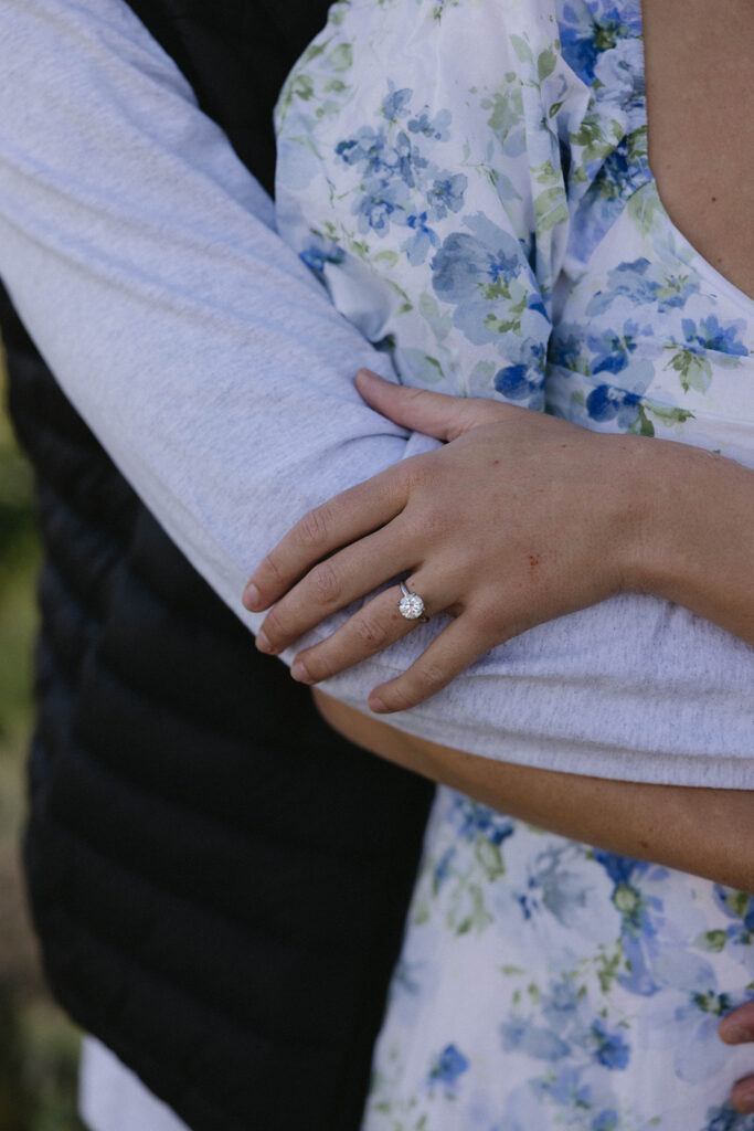 engagement ring photos close up with couple outfits detail shot
