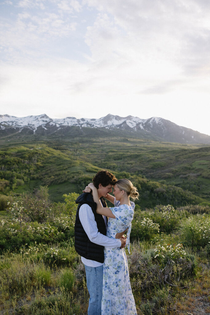 couple embracing in front of the mountains in eden utah