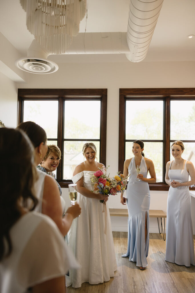first look with bridesmaids in getting ready suite