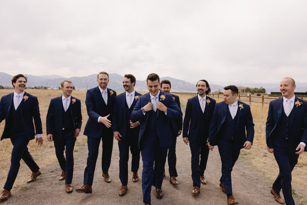 unique groomsmen poses candid groomsmen photos in the mountains for a spring wedding