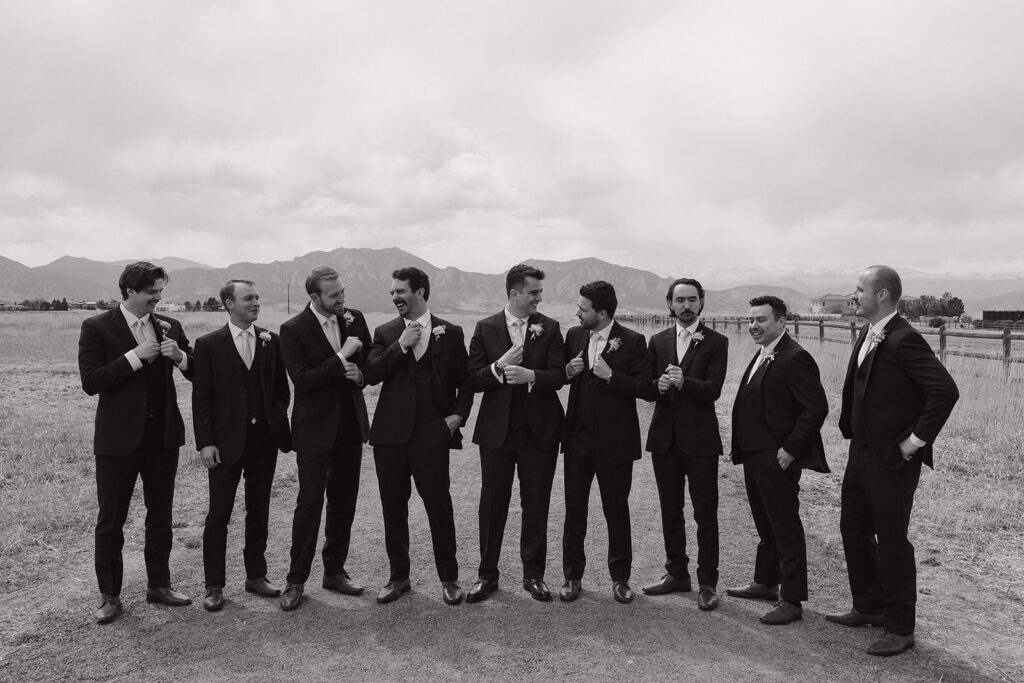 unique groomsmen poses candid groomsmen photos in the mountains for a spring wedding