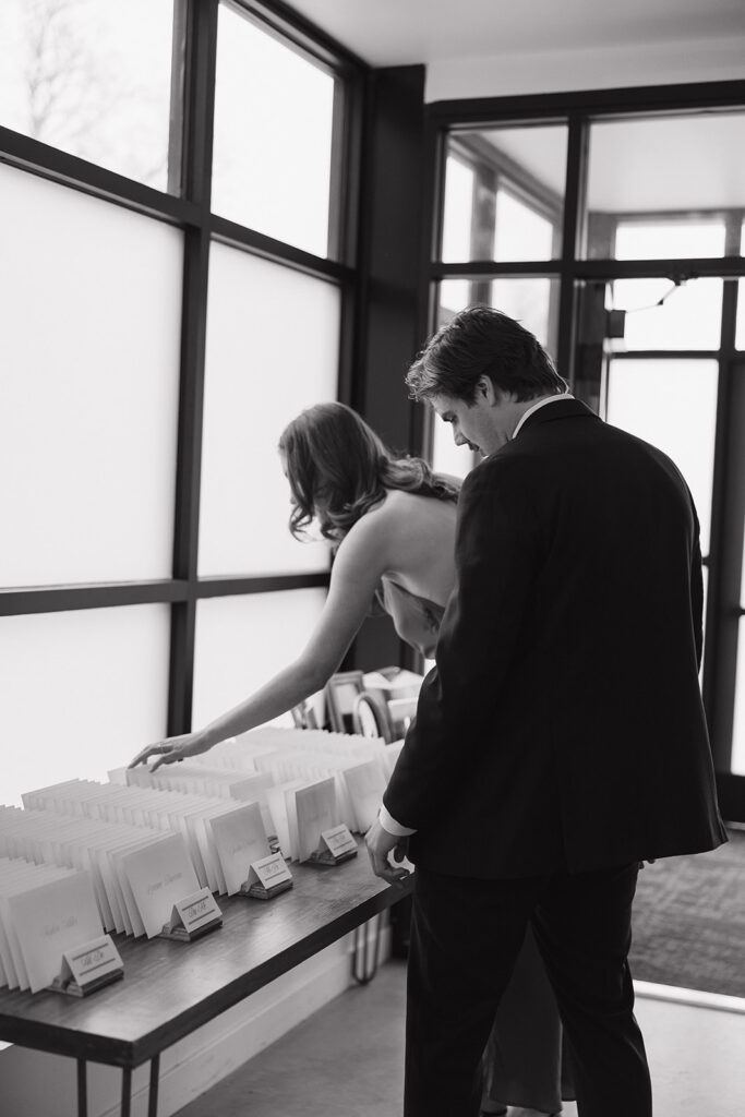 guests reading handwritten letters from the bride and groom at cocktail hour