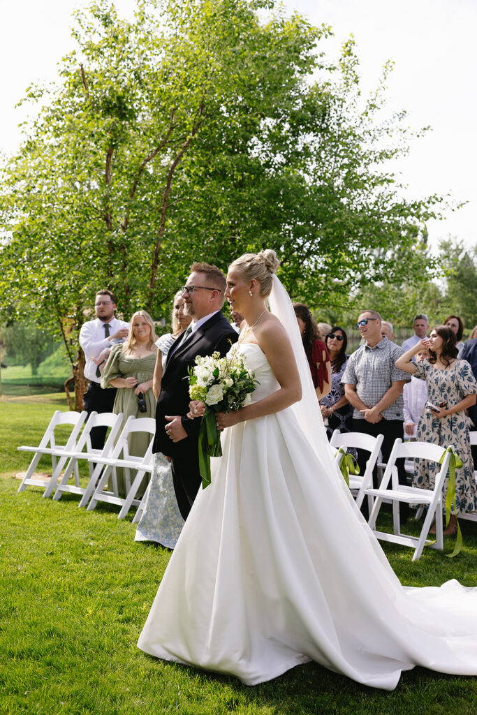 bride walking down the aisle for an outdoor wedding ceremony