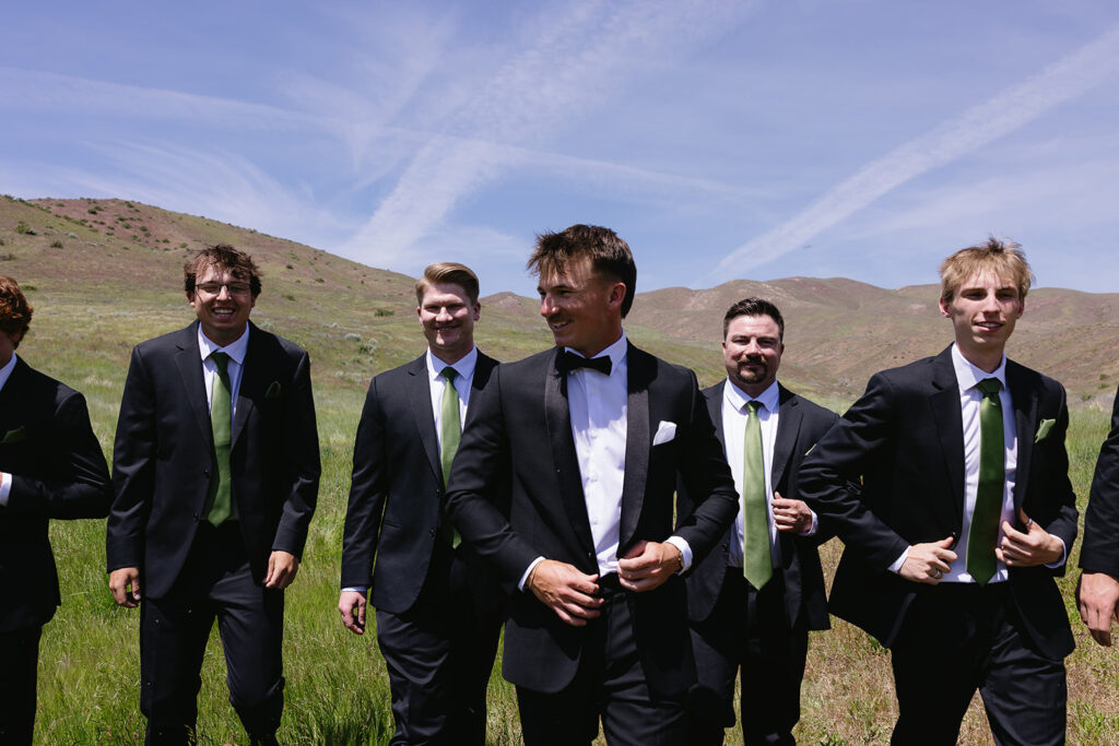 groomsmen walking side by side in a candid shot of bridal party