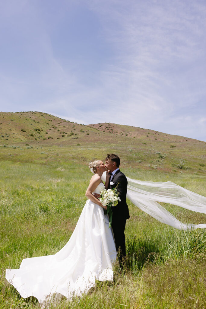 romantic wedding photos of the bride and groom with a mountain backdrop in boise idaho