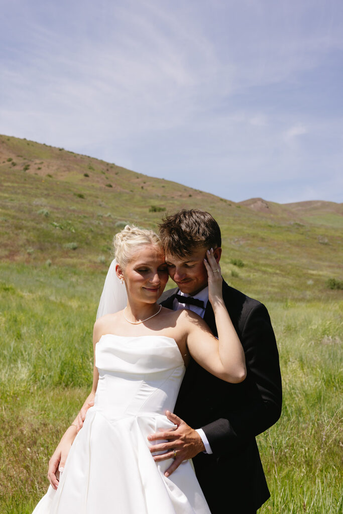 romantic wedding photos of the bride and groom with a mountain backdrop in boise idaho