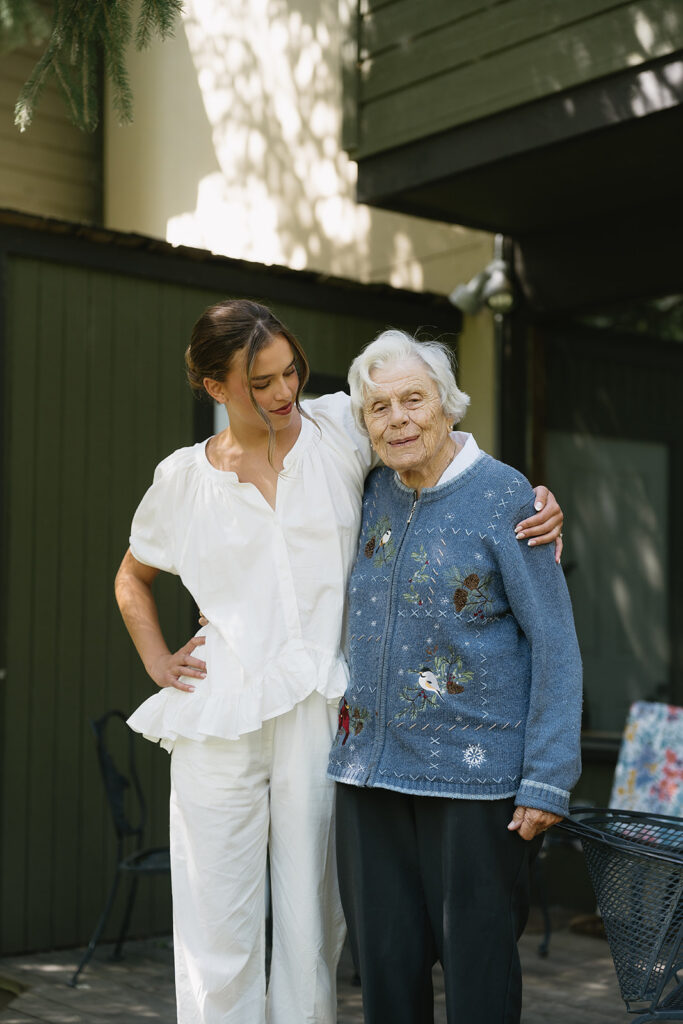 bride smiling with her grandmother getting ready wedding photos